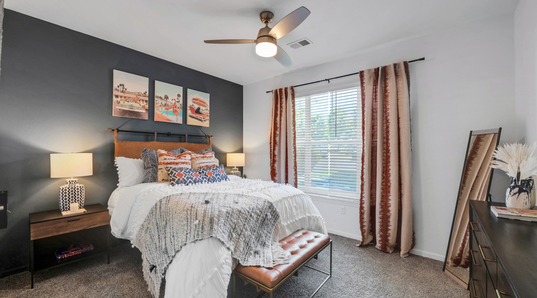 a bedroom with a bed and a fan