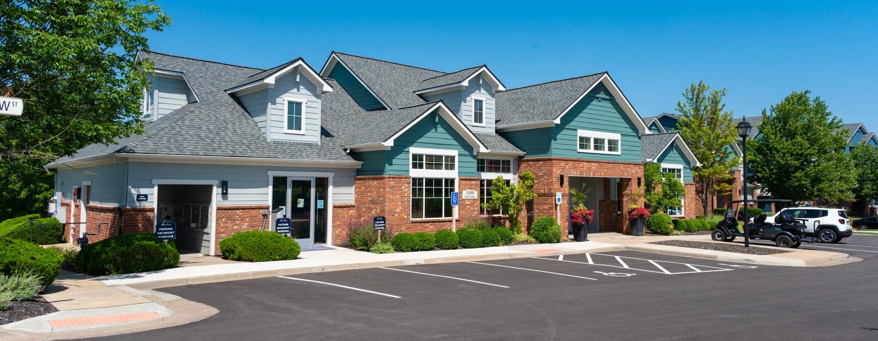 a leasing office with a golf cart out front