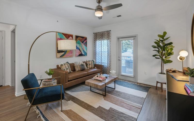 a living room with a couch and a fan